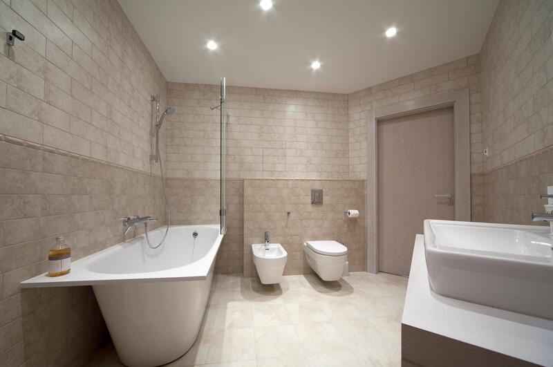 bathroom with vanities and toilet bowl